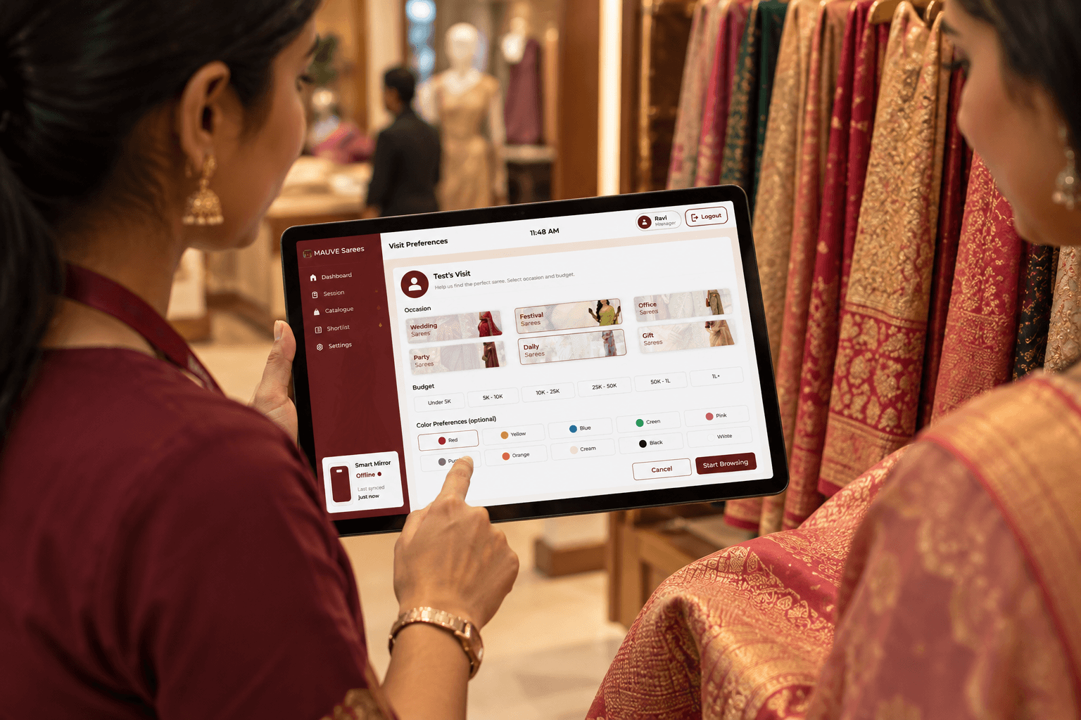 Store staff using the Wearify Sales Tablet beside a rack of sarees